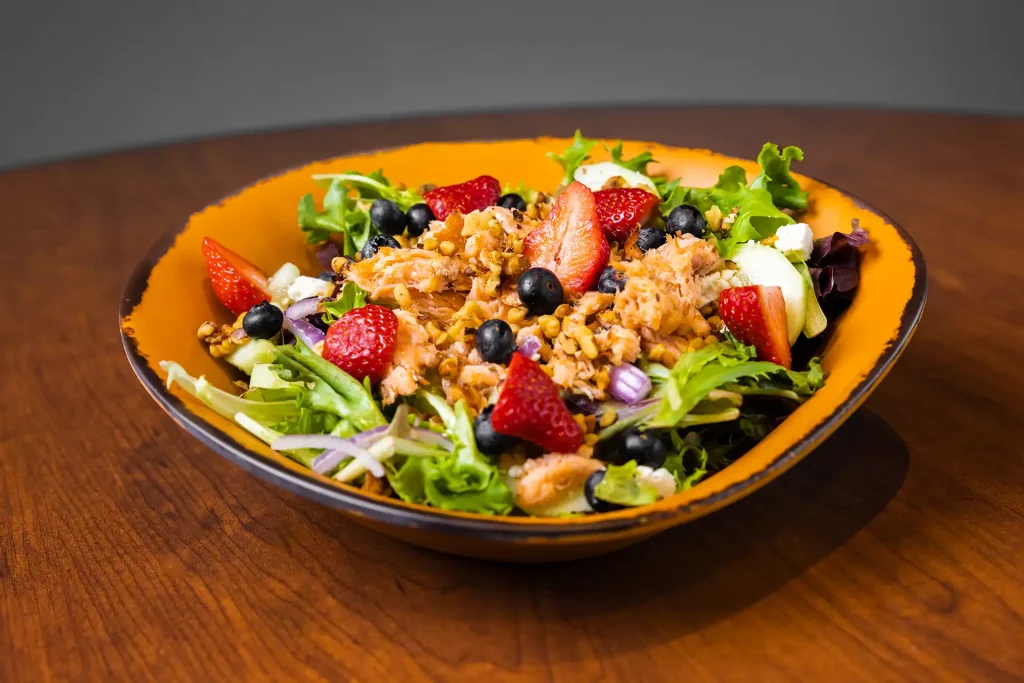 salmon salad in a bowl on a table.